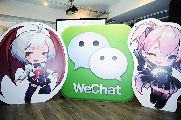 three cardboard cutouts of characters that read wechat