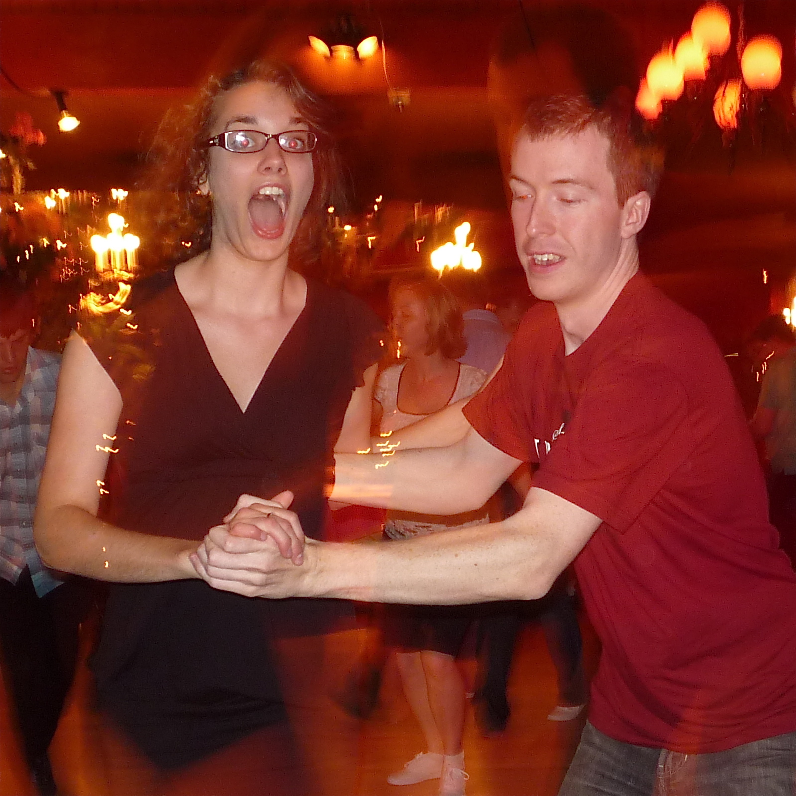 a man and woman are dancing at a party