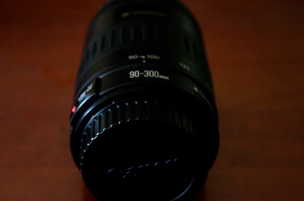 a large camera lens with a red light on