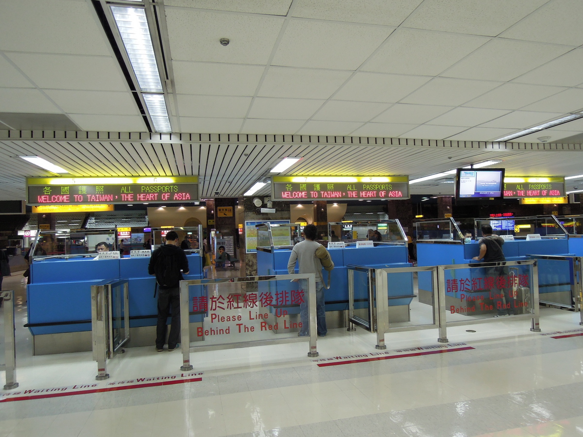 a group of people standing next to an airport