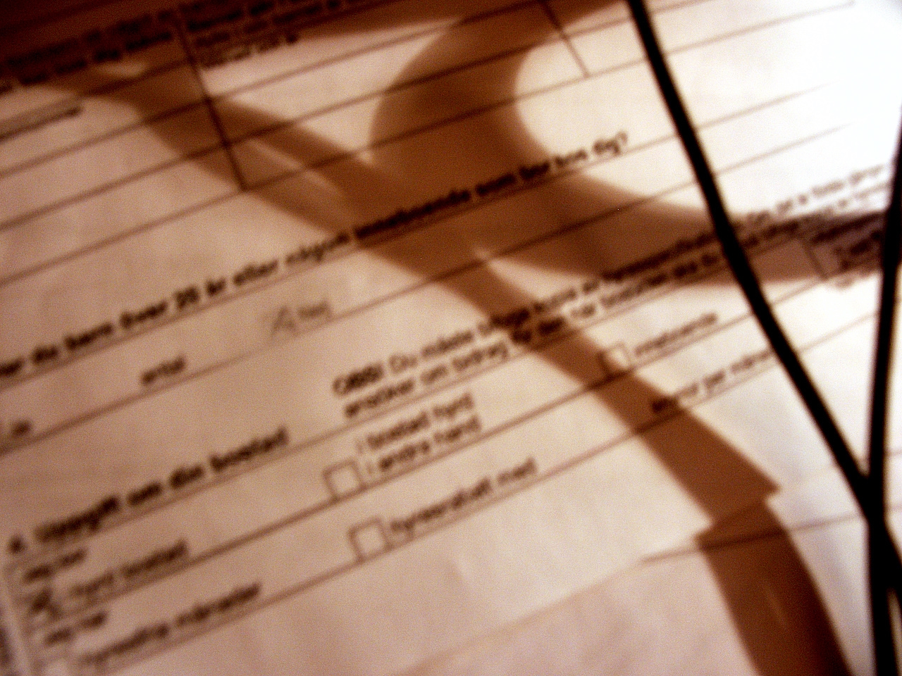 a check sheet with a shadow on it
