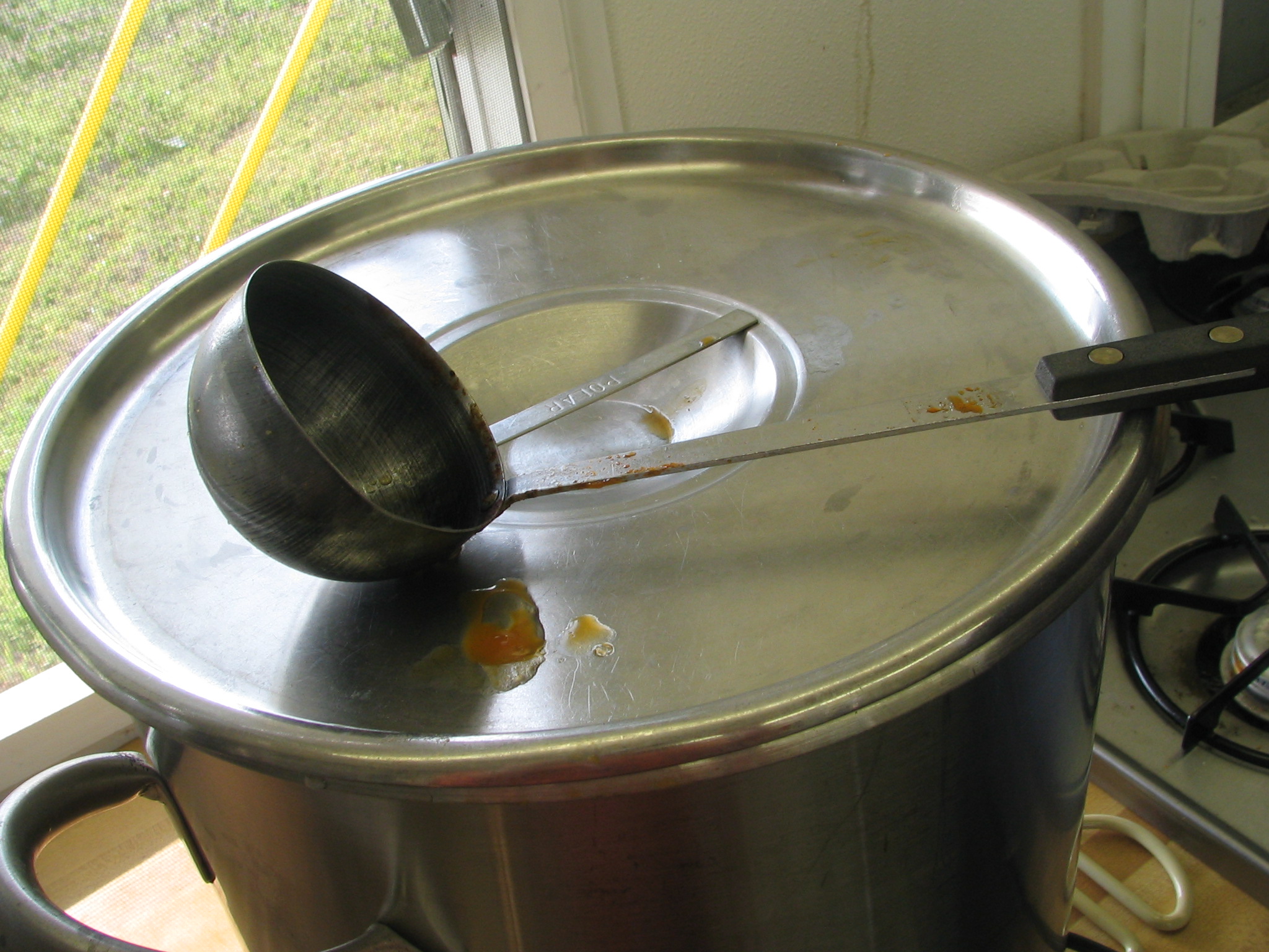 a steel pot with a metal spoon on it