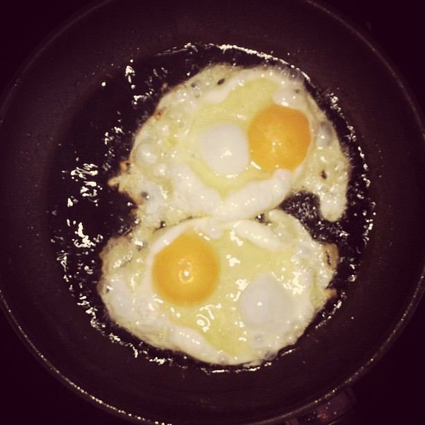 three eggs fry in a set on top of a stove
