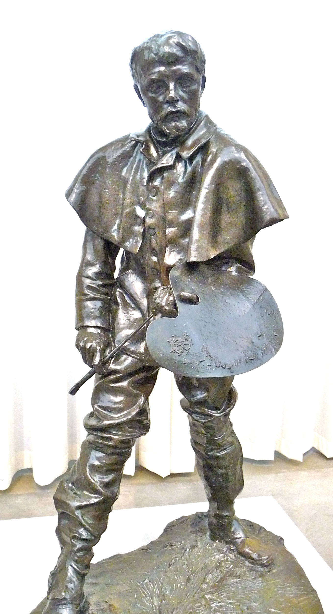 the bronze statue is depicting a man carrying a shield