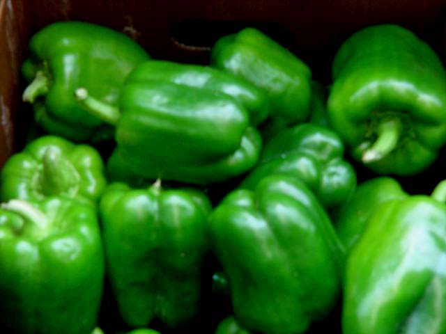 green peppers in a brown box on a table