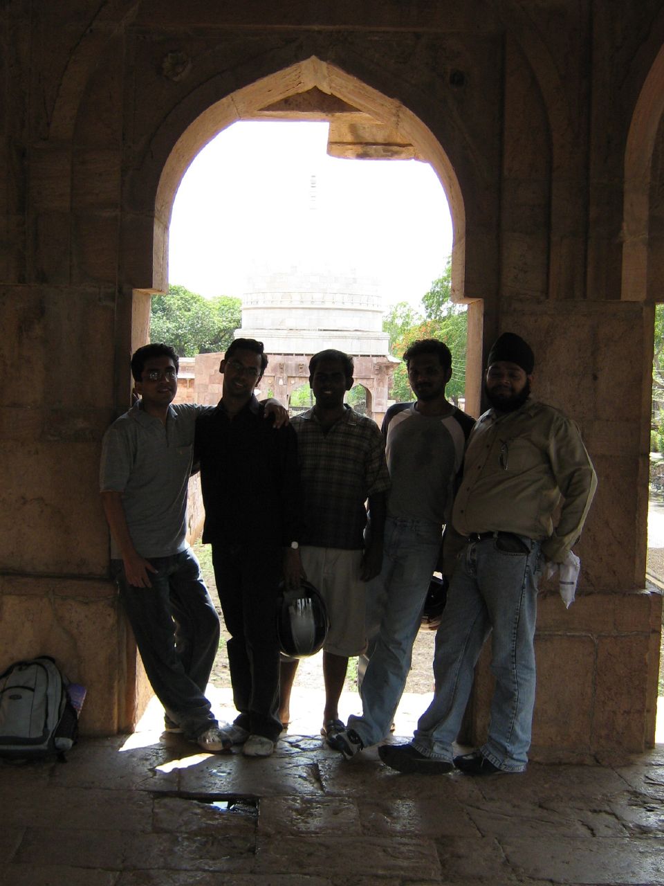 a group of men standing in an archway together