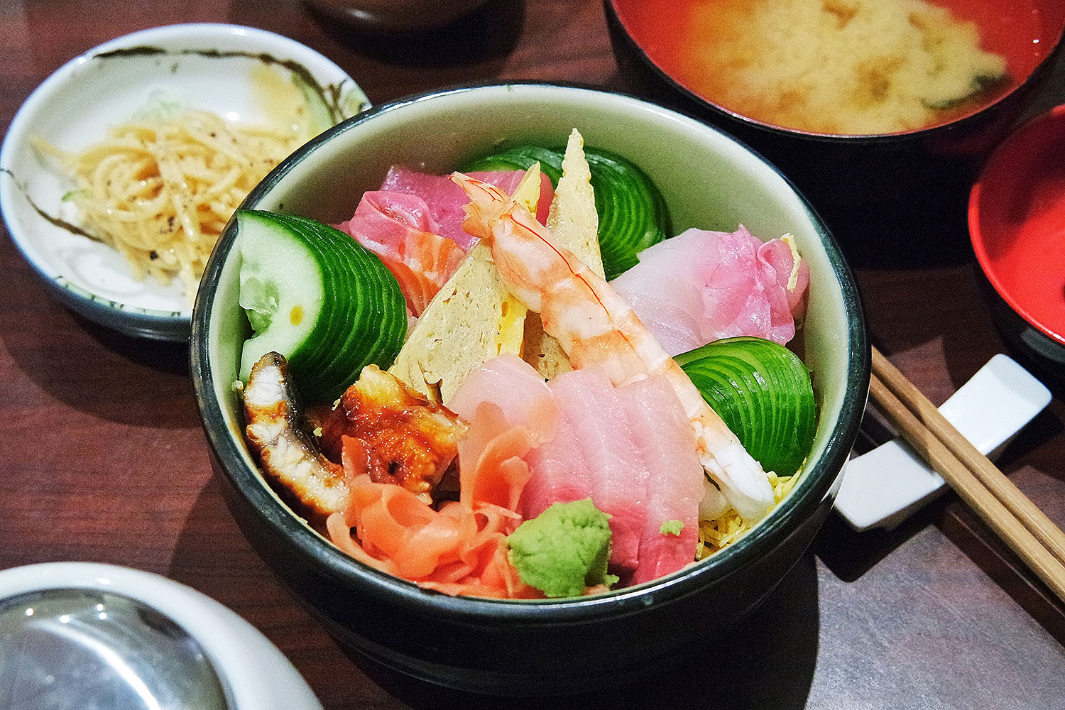 a couple of bowls of some food with chopsticks