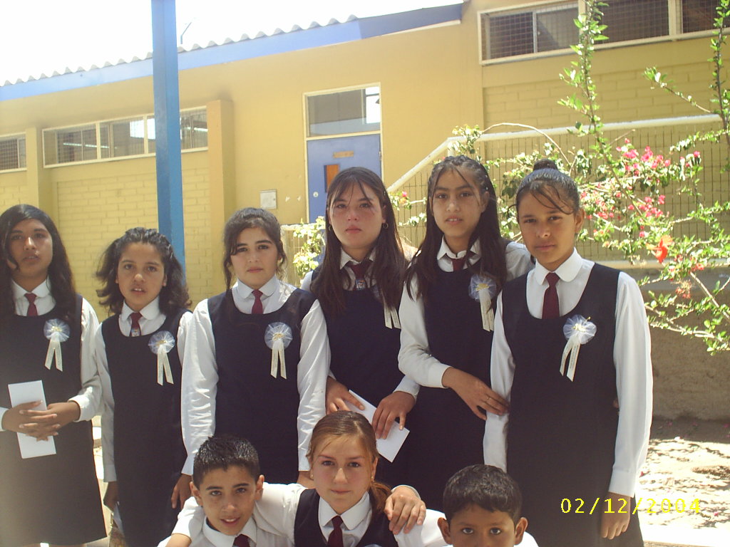 a group of children are posing in their uniforms