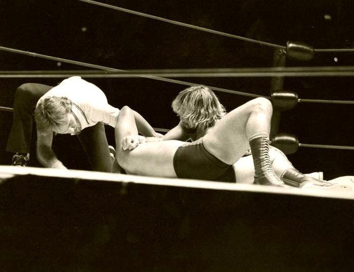 two men wrestling in the ring with each other