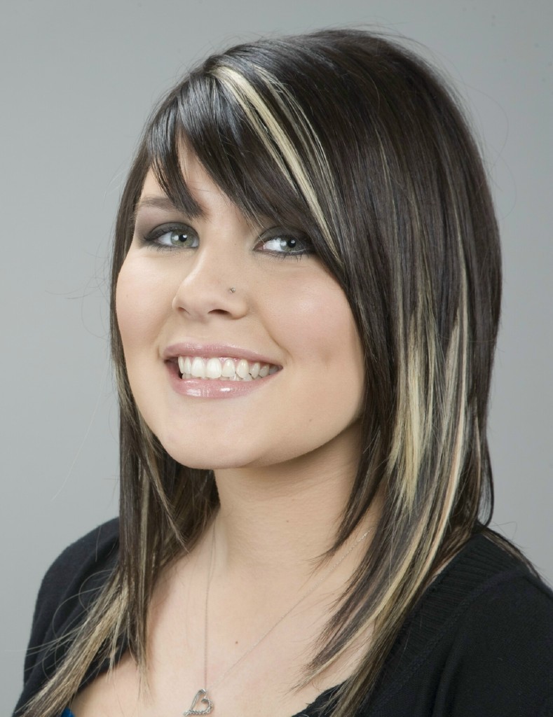 a woman with long hair is smiling in front of the camera