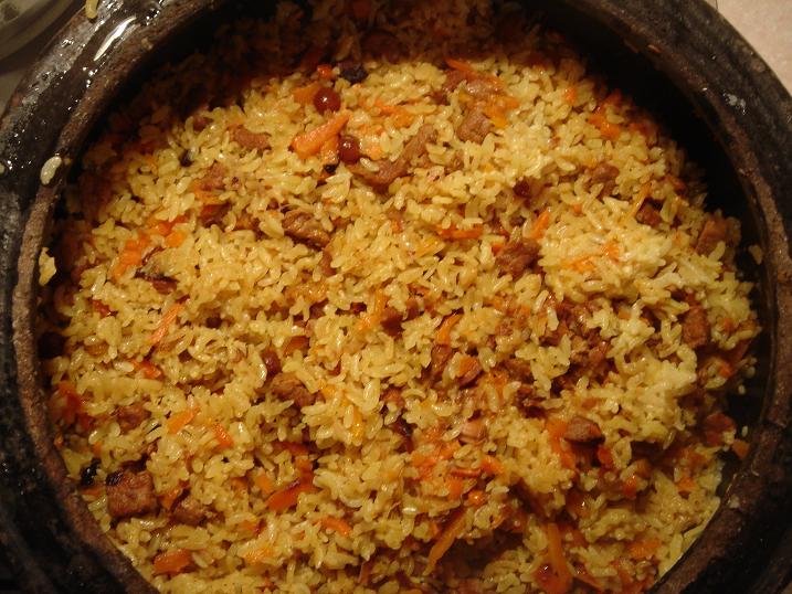 a close up of a dish that has rice and carrots