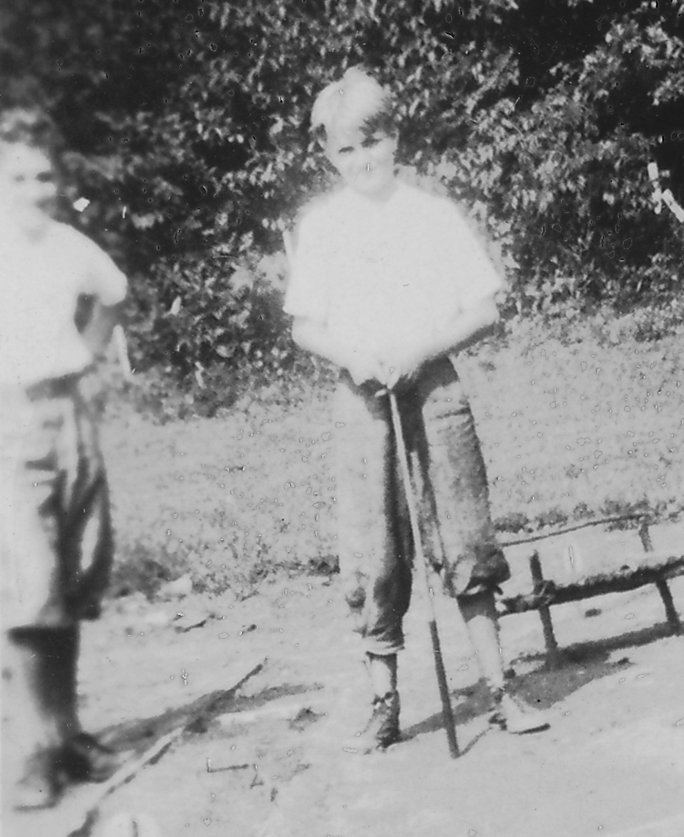 two boys playing with baseball bats in an old po