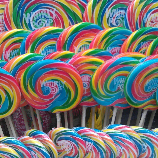 many lollipops on sticks sitting next to each other