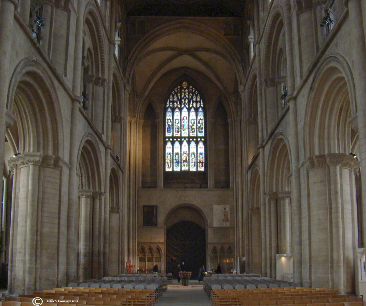 an indoor church with large pews and a big window