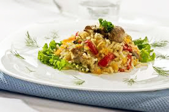 a plate filled with rice and mushrooms on top of a table