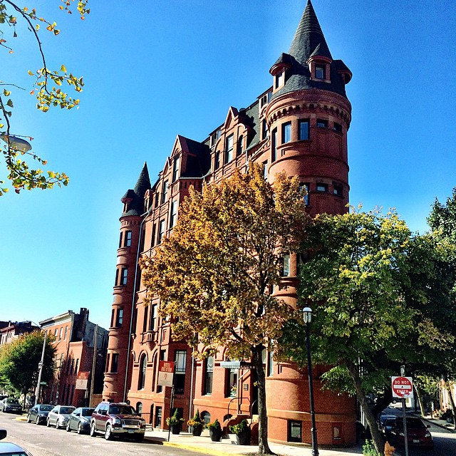 a tall red brick building with a turret top