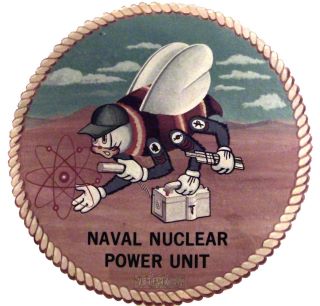 a circular sign with a man crawling on a disk that says naval nuclear power unit