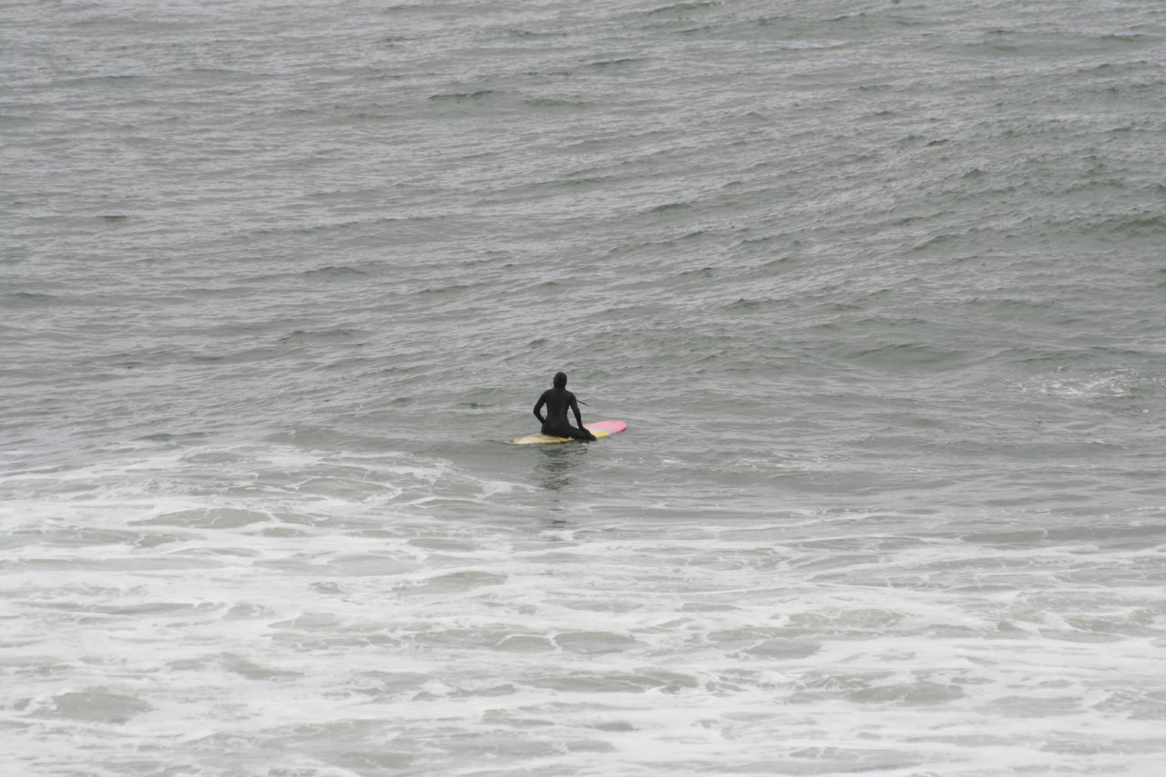the surfer is in the ocean riding his surfboard