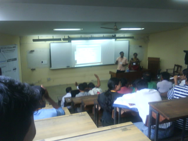 a class room full of students listening to a presenter