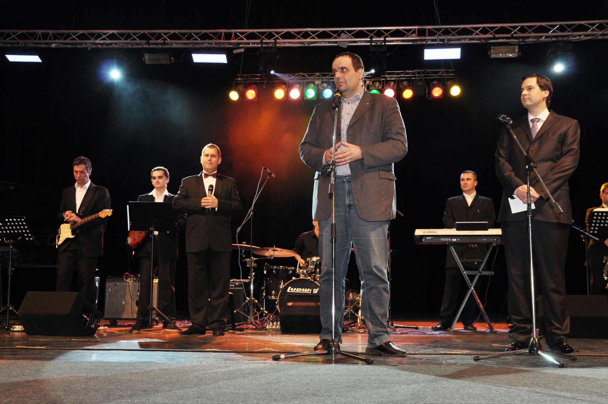 a group of men that are on stage with microphones