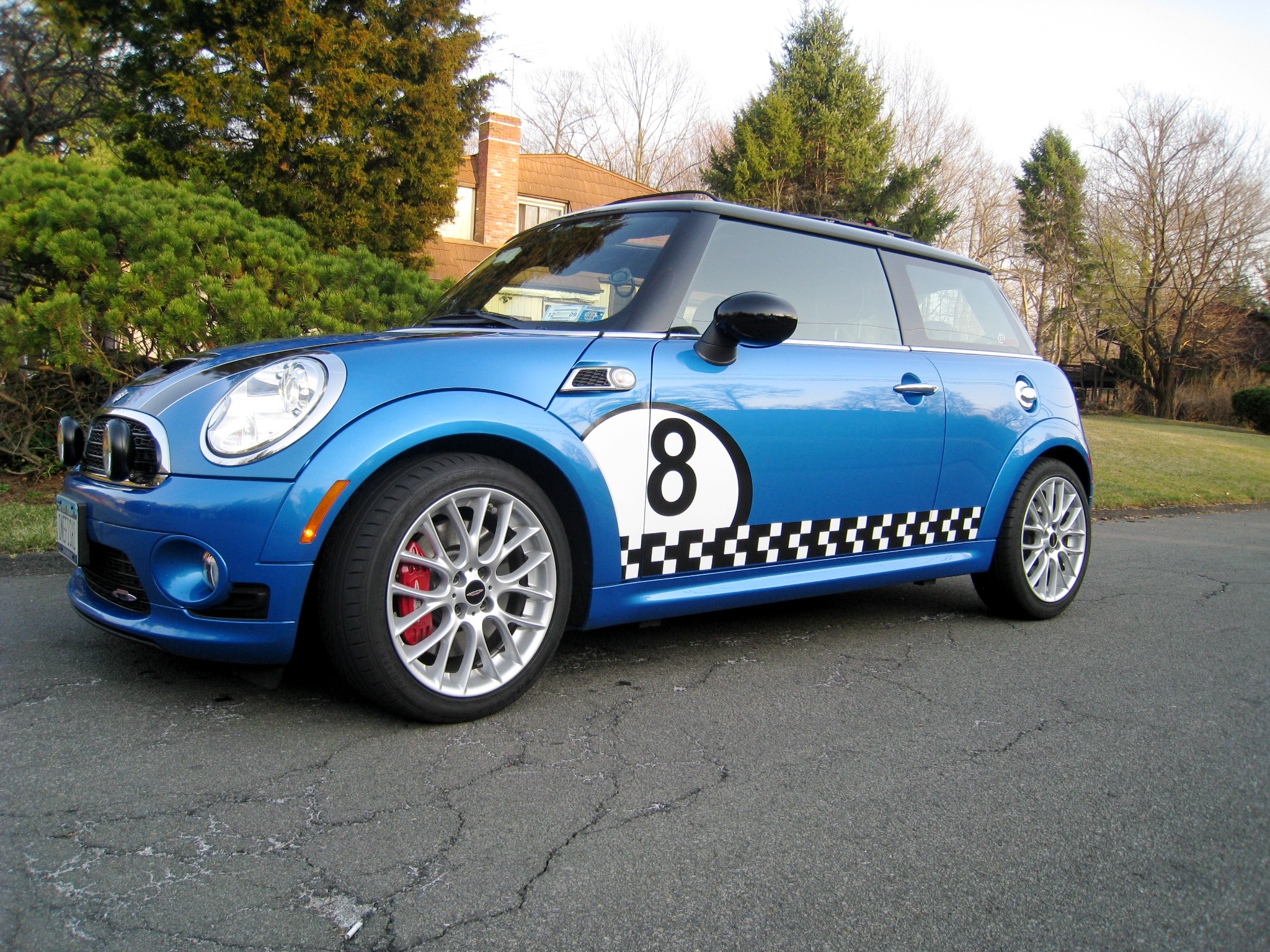 a small blue car with an interesting number on it