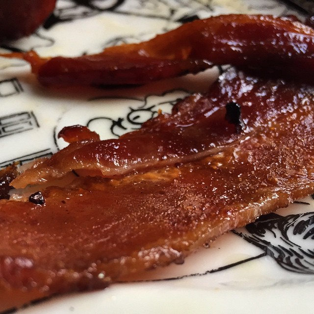 bacon strips sitting on top of a floral plate