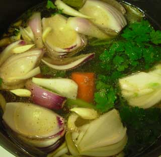 fresh broth mixed in with the ingredients to make vegetable soup