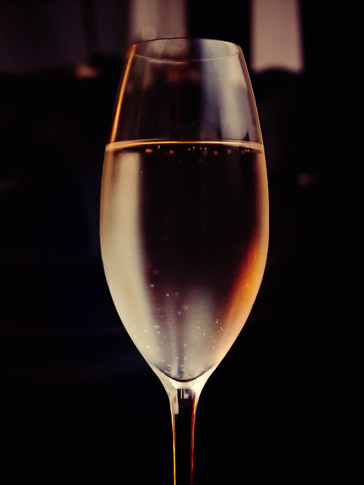 a wine glass is shown against a black background