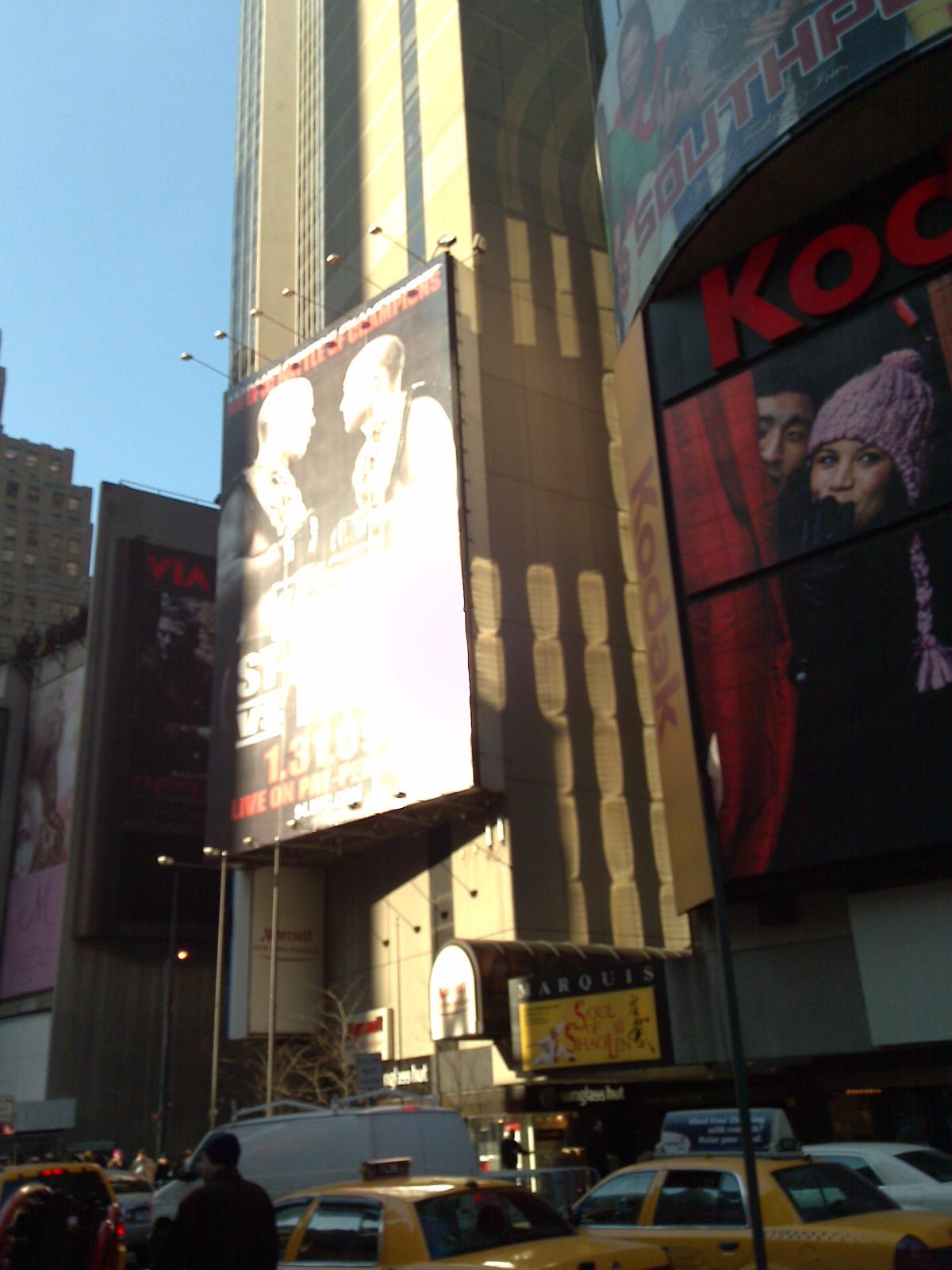 large billboards are attached to the sides of buildings