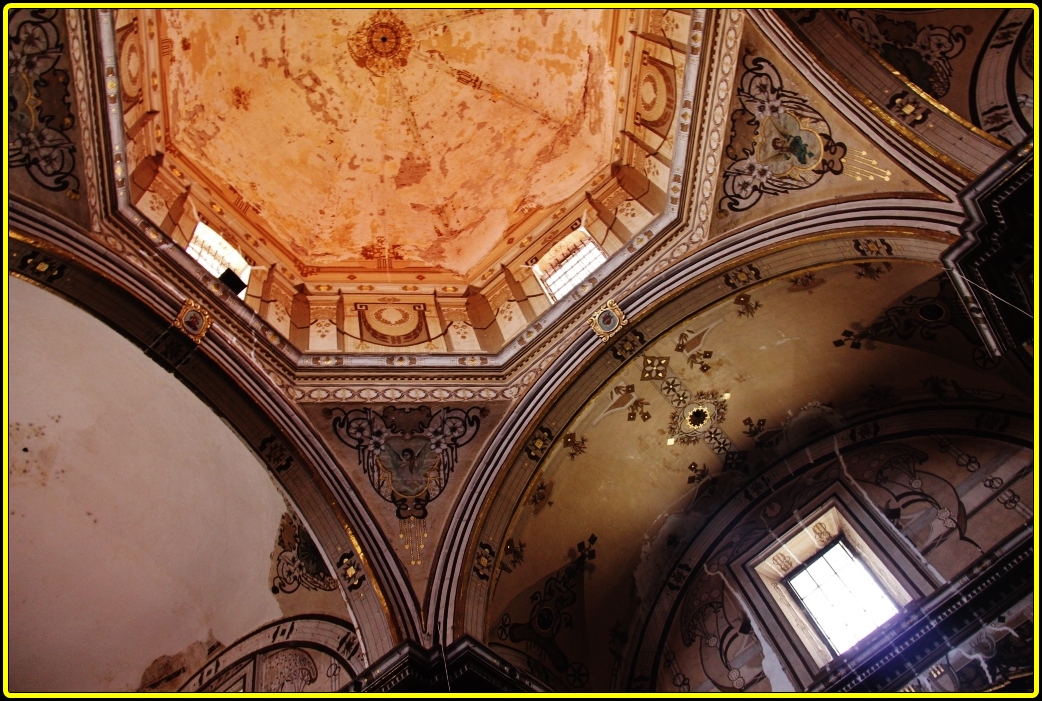 the inside of a building with stone decorations and intricate paint