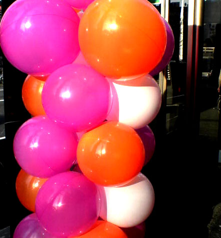 a tower made out of balloons on the street