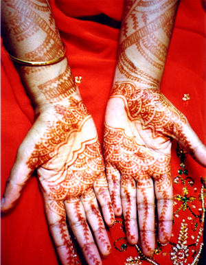 the hands are decorated with henna designs
