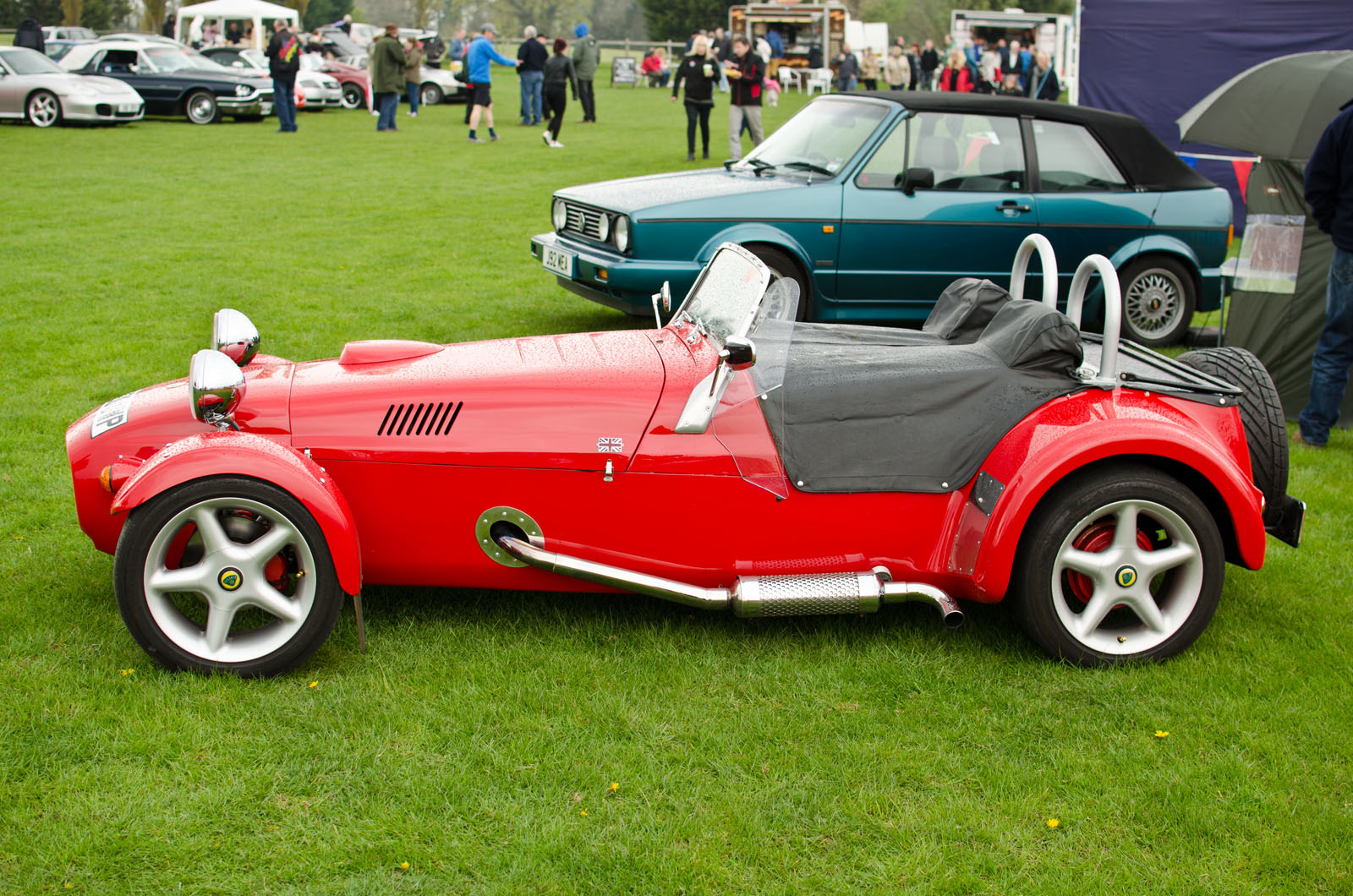 red vintage race car with side car attached to the engine