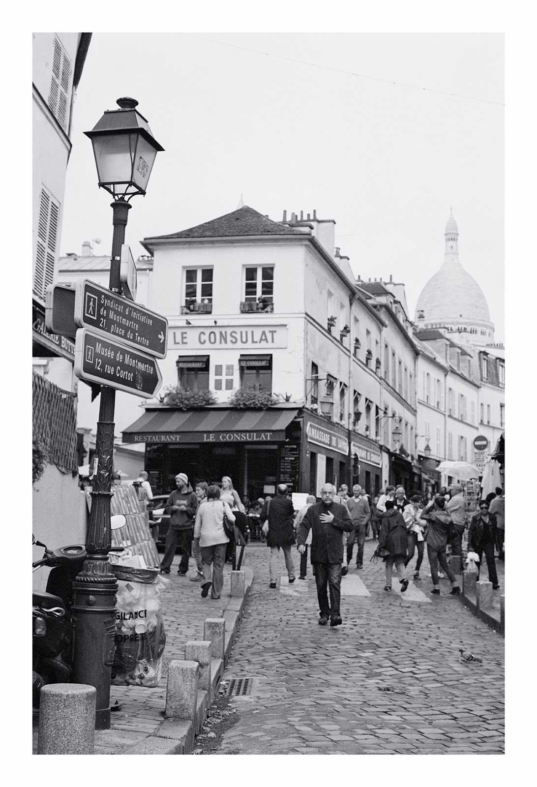 a group of people walk down the street