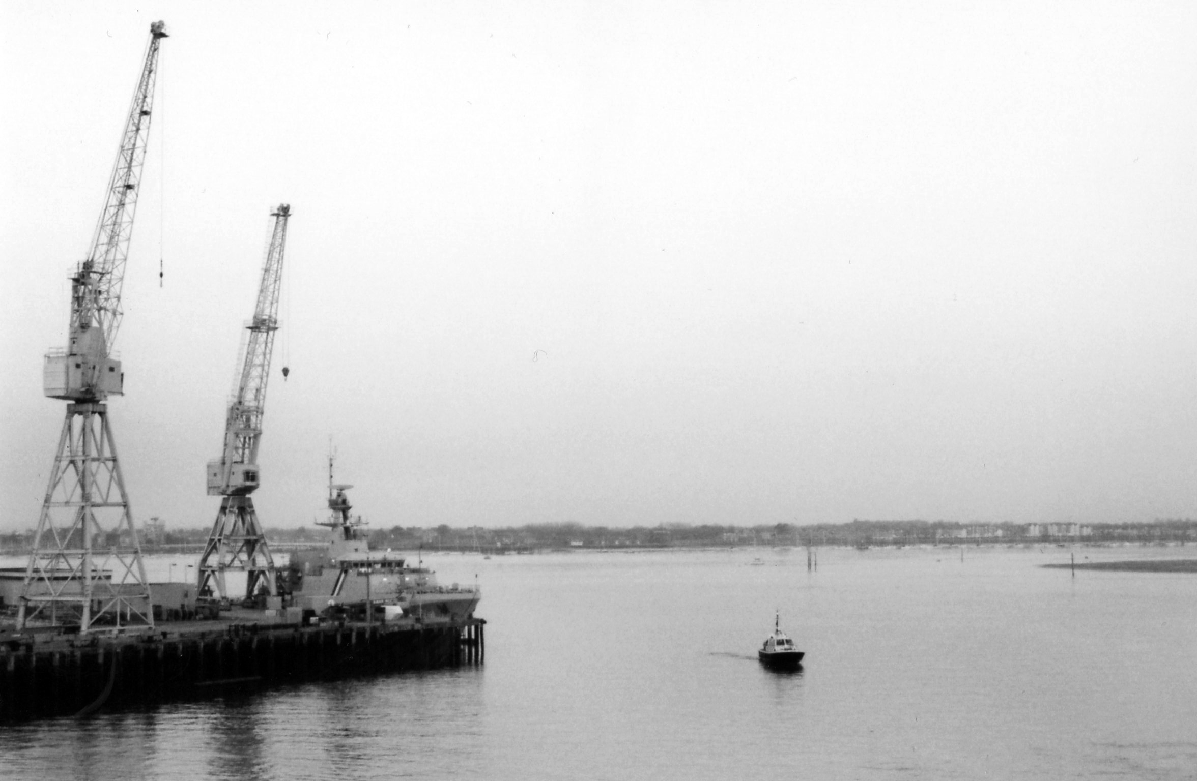 two cranes are shown next to a harbor