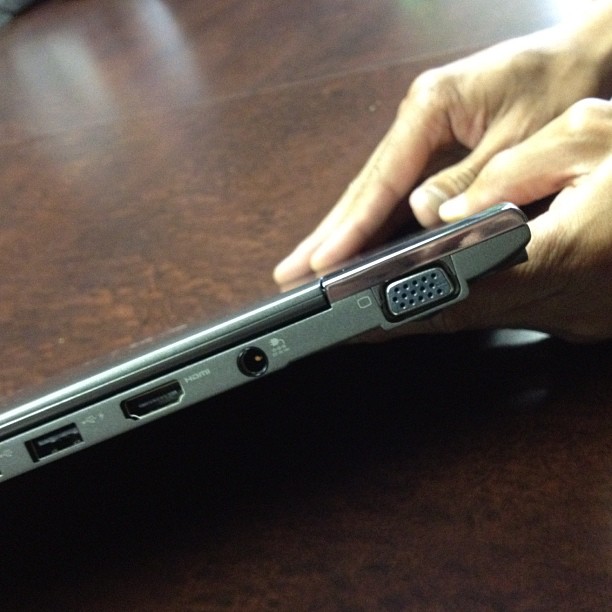 a person holding onto the handle of a laptop