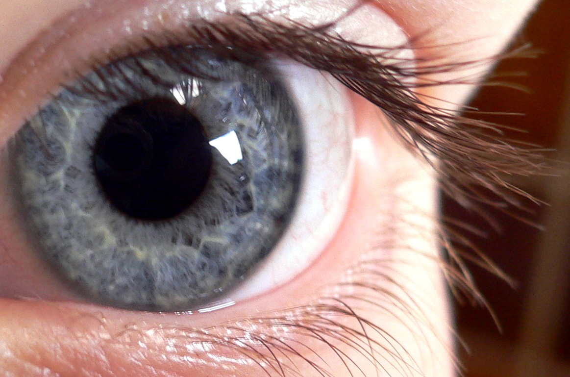 close up s of a child's eye with the iris partially closed