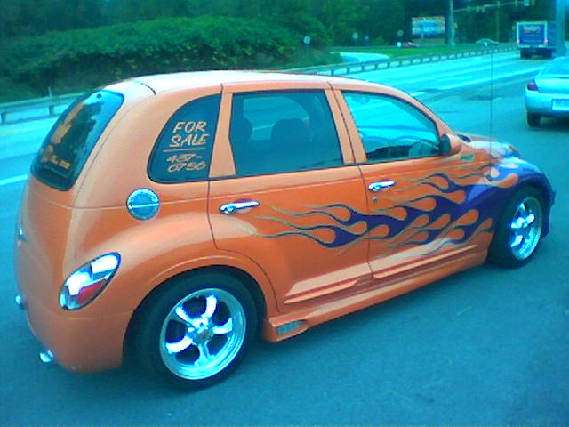 an orange car with a pink flame pattern on it