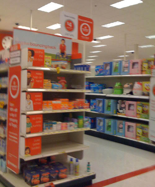 some orange signs some empty shelves in a store
