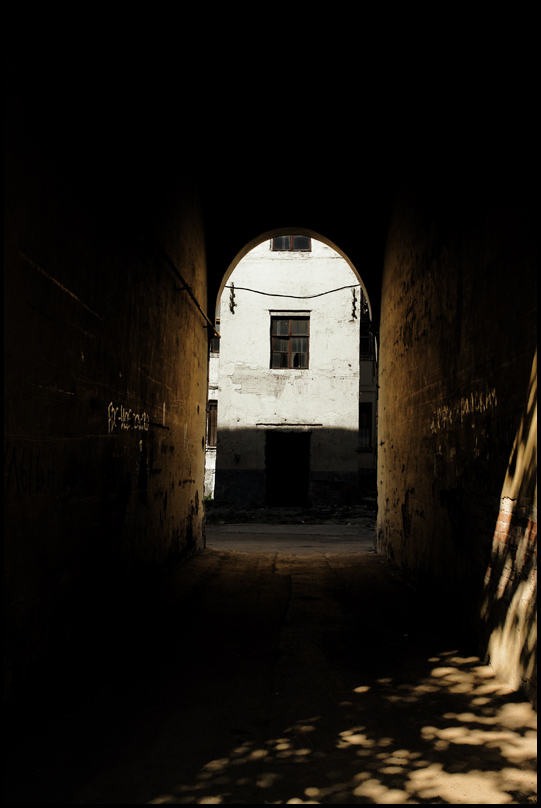 a dark alley with only one door open