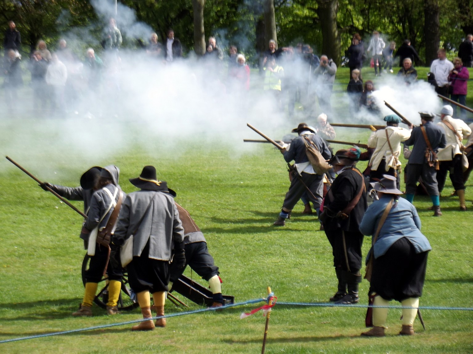 men in renaissance garb are on the ground with spears