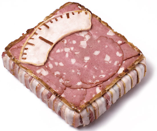 a square dish with meat and cheese in the center