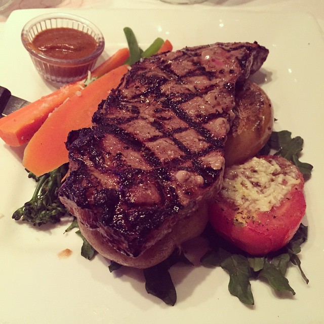 a steak is on a white plate and garnished with some sort of seasoning