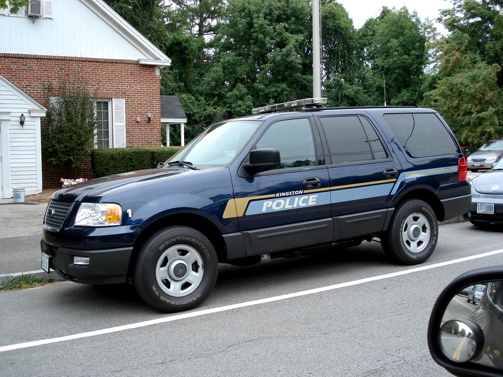 the police van is parked next to the stop sign