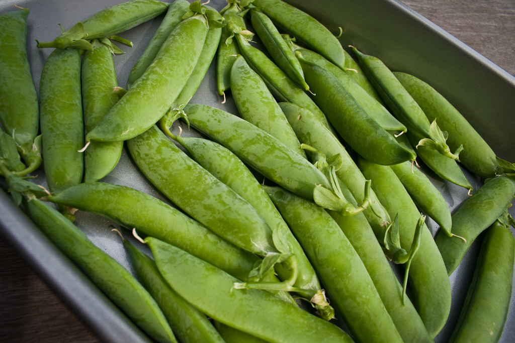 peas are being cooked in a pan on the table