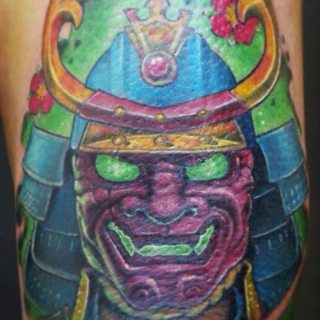 a man with a samurai face on his legs