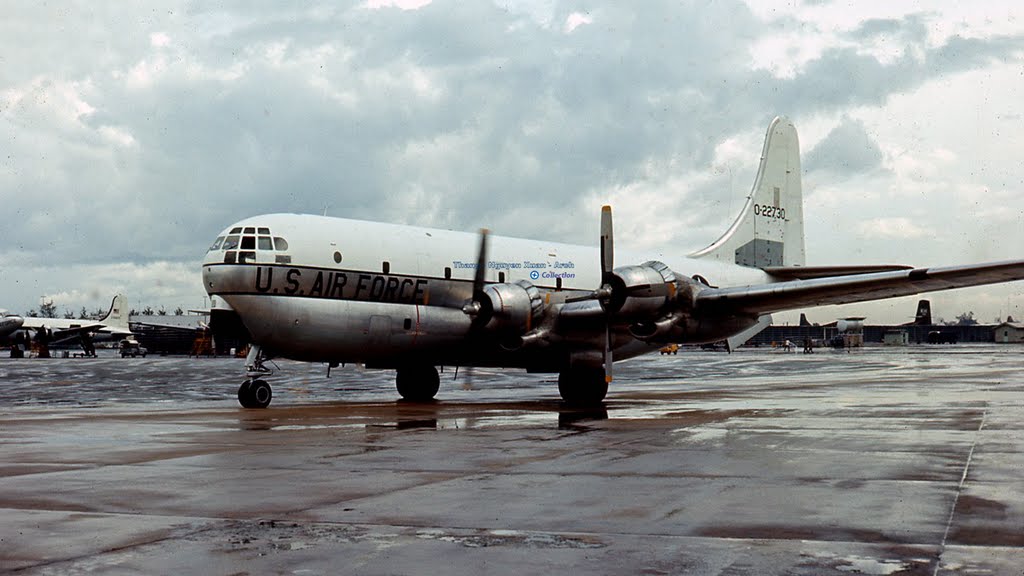 an airplane on the tarmac with clouds in the background