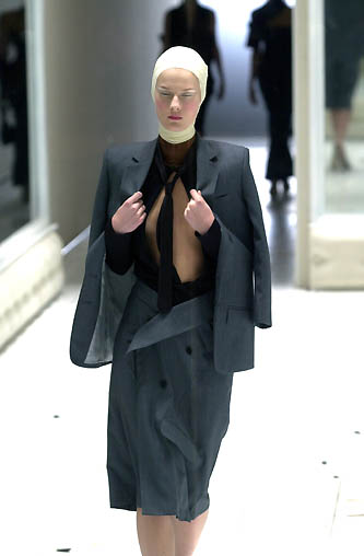 a women wearing a top and skirt on a runway