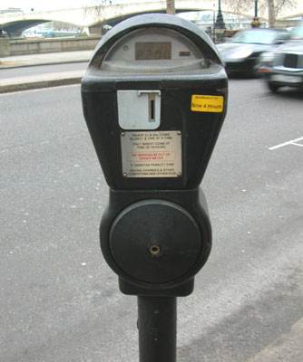 a parking meter that is on the side of the road