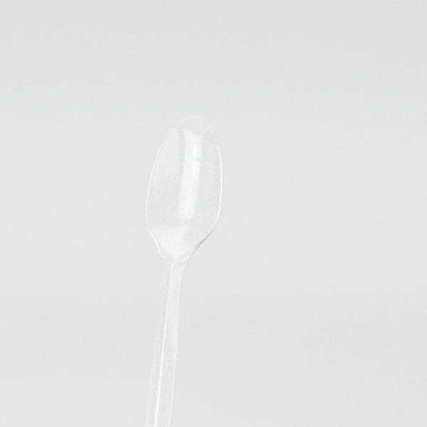 an empty spoon sitting on top of a table